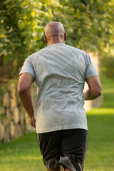 Fototapeta premium Mature fit African American man running outside.
