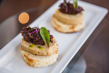 Homemade duck liver pate with bruschetta, greens and red onion jam