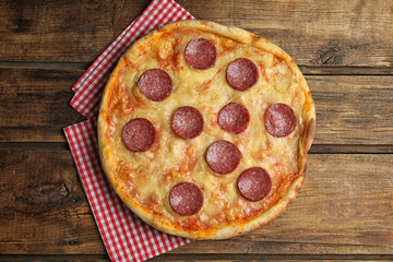 Tasty pepperoni pizza on wooden table, top view