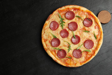 Tasty pepperoni pizza on black table, top view