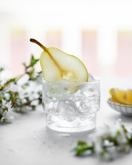 homemade pear lemonade in a glass on a light background