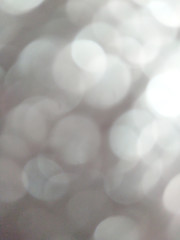 White and silver blur abstract background with bokeh lights for background 