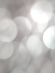 White and silver blur abstract background with bokeh lights for background 