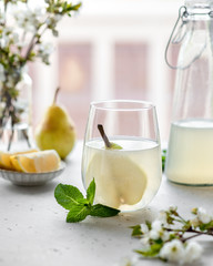 homemade pear lemonade in a glass on a light background