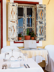 Fototapeta na wymiar Open restaurant terrace with amazing sea view on Santorini island. Cyclades, Greece