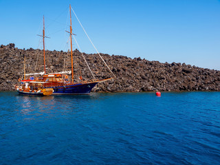 Moored Sailboat on the Aegean sea. Santorini volcano, Cyclades, Greece.