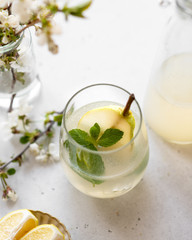 homemade pear lemonade in a glass on a light background