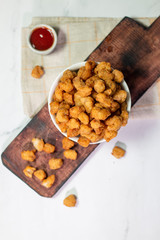 Stock photo of Homemade Crispy Popcorn Chicken with Sauce on white background