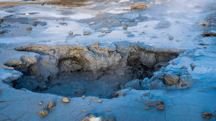 Crowd of smoking chimneys and puddles of boiling water in Hverir, Iceland.