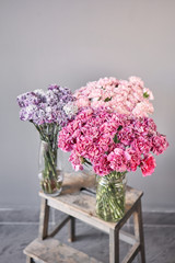 Bunches of carnation flowers different varieties in vases. Lovely Vintage background with flowers. Wallpapers. Clove bunch present for Mothers Day.