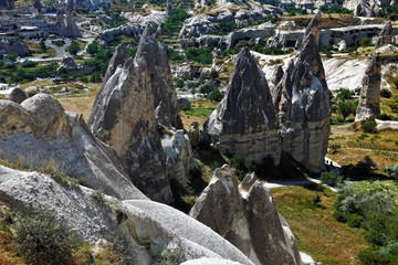 Amazing valley of Cappadocia with ancient cliffs. Unusual rocks with sharp peaks of gray and black. Caves were cut down in the rocks many centuries ago. UNESCO Heritage.