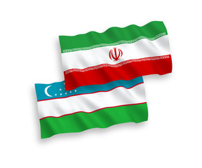 National vector fabric wave flags of Uzbekistan and Iran isolated on white background. 1 to 2 proportion.