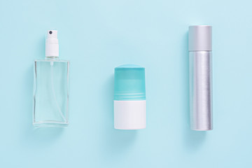 top view three cosmetic bottles on blue background, flat lay, mock up
