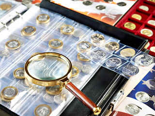 Numismatic coins with magnifying glass - obrazy, fototapety, plakaty
