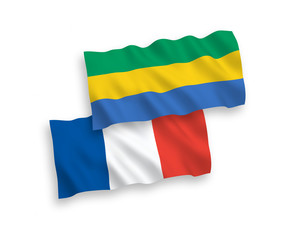 National vector fabric wave flags of France and Gabon isolated on white background. 1 to 2 proportion.