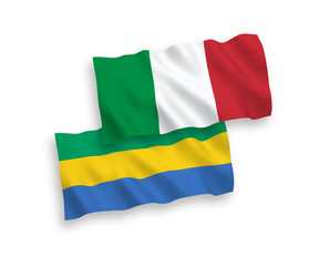 National vector fabric wave flags of Italy and Gabon isolated on white background. 1 to 2 proportion.