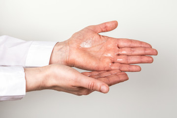 Fototapeta premium Woman cleaning hands with antibacterial alcohol disinfectant