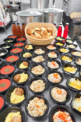 Food delivery. Different in plastic disposable lunch box with healthy natural food. Chicken broth, mashed soup, mashed potatoes with cutlet, seafood pasta, salads, pilaf with a fresh bun.