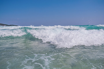 Fototapeta na wymiar Big sea water wave comming with clean blue sky