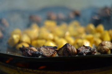 Potato and meat dish on fire
