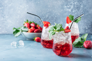 Red cocktail with ice and fresh strawberry
