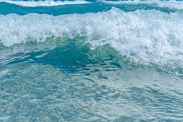 Big wave of ocean on sandy beach