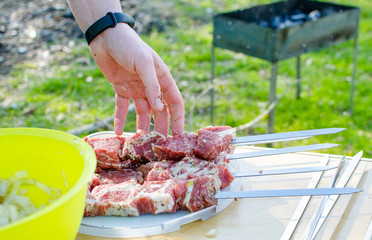 A lot of raw pork skewers on skewers.
