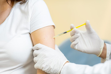 Vaccine injection procedure for a pregnant woman, cropped view without face