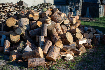 Firewood for furnace heating. Warehouse firewood for stove. Firewood stacked and prepared for winter Pile of wood logs