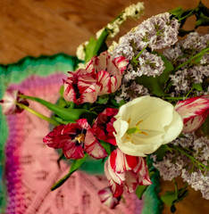 A bouquet of tulips and lilac close-up; horizontal banner with blurry background