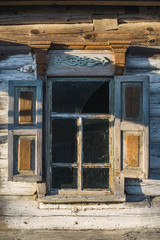 Old window of wooden house in Chernobyl exclusion zone.