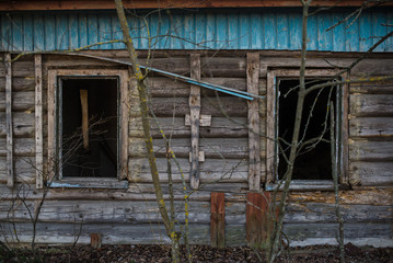 Old window of wooden house in Chernobyl exclusion zone.