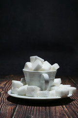 Close up of tea and sugar cube on black background.