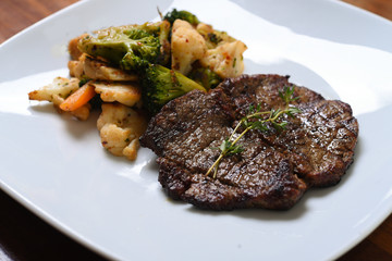 boiled vegetables and beef served on the plate