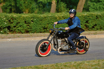 A view of a young man riding a motorcycle on an open road