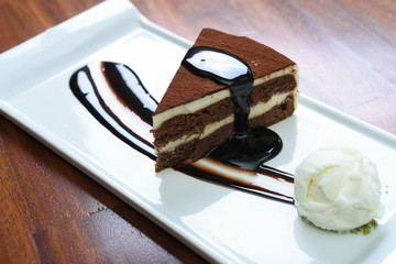 chocolate sauce and plain ice cream served on a white plate