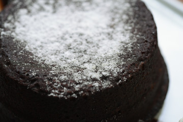 white souffle with chocolate sauce, powdered sugar and plain ice cream service details