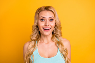 Fototapeta premium Closeup photo of funny attractive pretty lady long curly hairdo beaming smile good mood open mouth excited wear casual turquoise singlet isolated vivid shine yellow color background