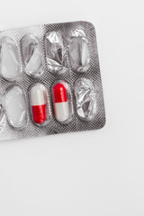 Bicolor capsules in blister pack from above on white background
