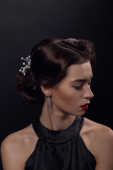 Beautiful gorgeous woman with elegant wavy hairstyle, bright make up.