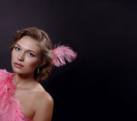 The beautiful girl in a beautiful pink dress on black background