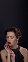 Beautiful gorgeous woman with elegant wavy hairstyle, bright make up.