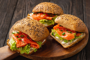 Sandwiches with salmon, lettuce and rye bread.