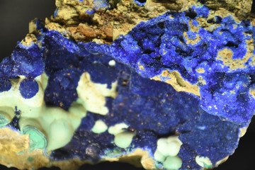 Different rock textures, many colors from blue to pink, white, dark, green, purple.
