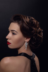 Beautiful gorgeous woman with elegant wavy hairstyle, bright make up.