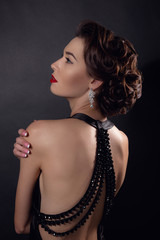 Beautiful gorgeous woman with elegant wavy hairstyle, bright make up.