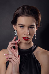 Beautiful gorgeous woman with elegant wavy hairstyle, bright make up.