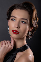 Beautiful gorgeous woman with elegant wavy hairstyle, bright make up.