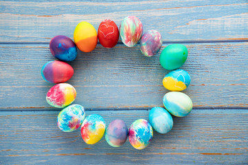 Obraz premium Easter decorated eggs. place for text on turquoise wooden background.