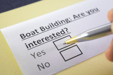 Obraz premium One person is answering question about boat building.